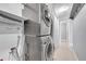 Conveniently located laundry room featuring a full-size, stackable washer and dryer at 7077 S Knolls Way, Centennial, CO 80122