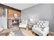 Cozy living room features a fireplace, hardwood floors, and comfortable white armchairs at 7077 S Knolls Way, Centennial, CO 80122