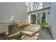 Private back patio with sliding glass door, seating, and a small garden bed at 7077 S Knolls Way, Centennial, CO 80122