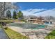 Community pool with fencing, a diving board, and mature trees at 7077 S Knolls Way, Centennial, CO 80122