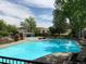 Inviting community pool surrounded by lush greenery and comfortable lounge chairs at 7077 S Knolls Way, Centennial, CO 80122