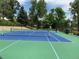 Well-maintained tennis court surrounded by lush greenery, perfect for active lifestyles at 7077 S Knolls Way, Centennial, CO 80122