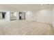 Expansive basement area with carpet, neutral walls, and access to more rooms and a staircase at 10000 E Yale Ave # 58, Denver, CO 80231
