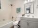 This cozy bathroom features a shower-tub and a modern vanity with light fixtures at 10000 E Yale Ave # 58, Denver, CO 80231