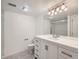 Bathroom featuring white vanity, mirror, and updated lighting at 10000 E Yale Ave # 58, Denver, CO 80231