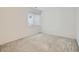 Bright bedroom with neutral carpet, large window, and fresh, white paint at 10000 E Yale Ave # 58, Denver, CO 80231
