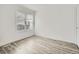 This bedroom has wood-look flooring and a large window with blinds at 10000 E Yale Ave # 58, Denver, CO 80231