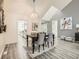 Elegant dining room with modern table, chandelier, stylish seating, and a view into the modern kitchen at 10000 E Yale Ave # 58, Denver, CO 80231