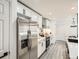 A modern kitchen featuring stainless steel appliances, white cabinets, and sleek gray flooring at 10000 E Yale Ave # 58, Denver, CO 80231
