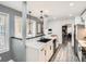 A kitchen featuring an island with a black sink, pendant lighting, and modern appliances at 10000 E Yale Ave # 58, Denver, CO 80231