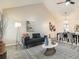 Spacious living room featuring vaulted ceilings, stylish furnishings, and an open flow to the dining area at 10000 E Yale Ave # 58, Denver, CO 80231