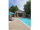 Inviting community pool area with lounge chairs, sun umbrellas, and a shaded cabana for relaxation at 10000 E Yale Ave # 58, Denver, CO 80231