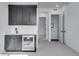 Contemporary bar area with black cabinets, a mini-fridge, and a sink at 24741 E 33Rd Dr, Aurora, CO 80019