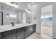 Bright bathroom featuring a double vanity with sleek black cabinets and modern fixtures at 24741 E 33Rd Dr, Aurora, CO 80019