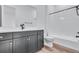 Modern bathroom featuring black vanity with double sinks, white countertop, and bath tub at 24741 E 33Rd Dr, Aurora, CO 80019