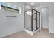 An enclosed glass shower has modern design and neutral colored tile at 24741 E 33Rd Dr, Aurora, CO 80019