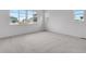 Bright bedroom featuring carpet floors and two large windows at 24741 E 33Rd Dr, Aurora, CO 80019