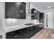 Stylish kitchen featuring dark cabinets, white backsplash, and stainless steel range at 24741 E 33Rd Dr, Aurora, CO 80019