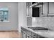 Bright kitchen with stainless steel appliances, gray cabinets, and a large window at 24741 E 33Rd Dr, Aurora, CO 80019