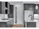 Modern kitchen featuring dark cabinetry and stainless steel appliances at 24741 E 33Rd Dr, Aurora, CO 80019