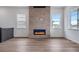 Living area features a fireplace with a stone surround and ample sunlight at 24741 E 33Rd Dr, Aurora, CO 80019