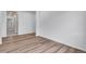 Open-concept room with sleek wood floors and freshly painted white walls at 24741 E 33Rd Dr, Aurora, CO 80019