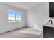 Bright, minimalist room with a large window and neutral carpet at 24741 E 33Rd Dr, Aurora, CO 80019