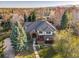Stunning aerial view of an elegant brick and stucco home showing lush landscaping, mature trees, and inviting curb appeal at 2464 Ginny Way, Lafayette, CO 80026