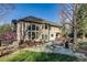 Expansive landscaped backyard featuring mature trees, a large deck, and comfortable outdoor seating at 2464 Ginny Way, Lafayette, CO 80026