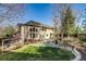 Beautiful backyard with a large deck, ample seating, and lush landscaping, ideal for outdoor gatherings at 2464 Ginny Way, Lafayette, CO 80026