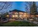 Expansive backyard featuring a spacious deck and outdoor seating, perfect for entertaining guests at twilight at 2464 Ginny Way, Lafayette, CO 80026