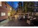 A dark wooden deck featuring comfortable wicker seating surrounds a charming fire pit perfect for evening relaxation at 2464 Ginny Way, Lafayette, CO 80026