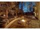 Inviting backyard with a stone fire pit and a raised patio area, perfect for outdoor entertaining at 2464 Ginny Way, Lafayette, CO 80026