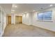 Unfinished basement with a window, neutral carpet, built-in shelving, and recessed lighting at 2464 Ginny Way, Lafayette, CO 80026