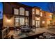 Outdoor deck with comfortable seating, lighting, and elegant design, ideal for entertaining in the evening at 2464 Ginny Way, Lafayette, CO 80026