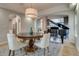 Elegant dining room with arched doorways and views of the grand piano and natural light coming in through large windows at 2464 Ginny Way, Lafayette, CO 80026