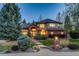 Elegant brick and stucco two-story home boasts professional landscaping and a welcoming entrance with manicured bushes at 2464 Ginny Way, Lafayette, CO 80026