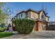 Charming home featuring brick accents, mature landscaping, and a well-manicured lawn, exuding curb appeal at 2464 Ginny Way, Lafayette, CO 80026
