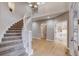 Grand foyer with a winding staircase, light hardwood floors, and modern lighting creates a welcoming ambiance at 2464 Ginny Way, Lafayette, CO 80026