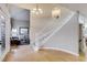 Welcoming foyer with a staircase, hardwood floors, and an open view into the living room with neutral tones at 2464 Ginny Way, Lafayette, CO 80026