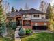 Charming brick home featuring a grand archway entrance, manicured lawn, and mature landscaping at 2464 Ginny Way, Lafayette, CO 80026