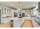 The well-lit kitchen features a large center island with cooktop and modern stainless steel appliances at 2464 Ginny Way, Lafayette, CO 80026
