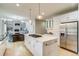 Bright kitchen features a center island with a cooktop and stainless steel appliances at 2464 Ginny Way, Lafayette, CO 80026