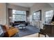 Bright living room featuring large windows, hardwood floors, and comfortable seating at 2464 Ginny Way, Lafayette, CO 80026