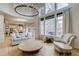 Inviting living room with lots of natural light, hardwood floors, modern lighting, and cozy seating at 2464 Ginny Way, Lafayette, CO 80026