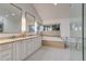 Light-filled main bathroom features a soaking tub, glass shower, and double vanity at 2464 Ginny Way, Lafayette, CO 80026