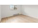 Simple bedroom with hardwood floors and a window at 14652 E 2Nd Ave # 202D, Aurora, CO 80011