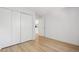 Bright bedroom featuring hardwood floors and spacious closet at 14652 E 2Nd Ave # 202D, Aurora, CO 80011