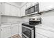 Kitchen features stainless steel appliances and white cabinets at 14652 E 2Nd Ave # 202D, Aurora, CO 80011