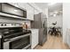 Modern kitchen with stainless steel appliances and marble countertops at 14652 E 2Nd Ave # 202D, Aurora, CO 80011